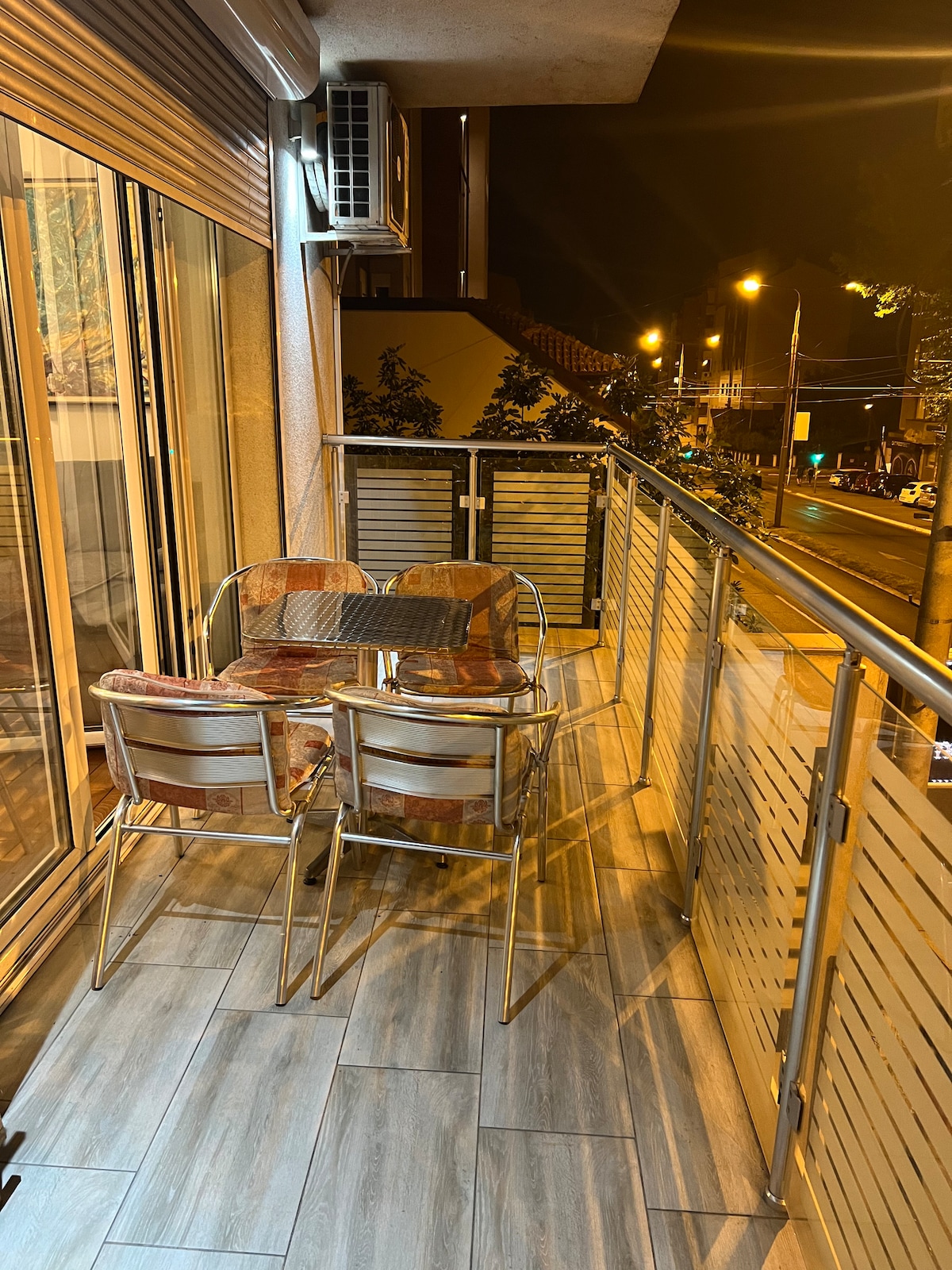 The spacious balcony with outdoor seating and a street view