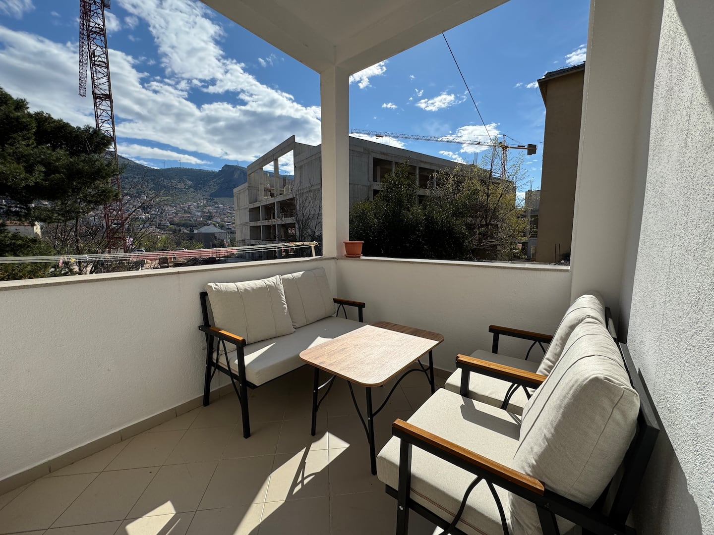 Spacious private terrace with outdoor sofas and a table