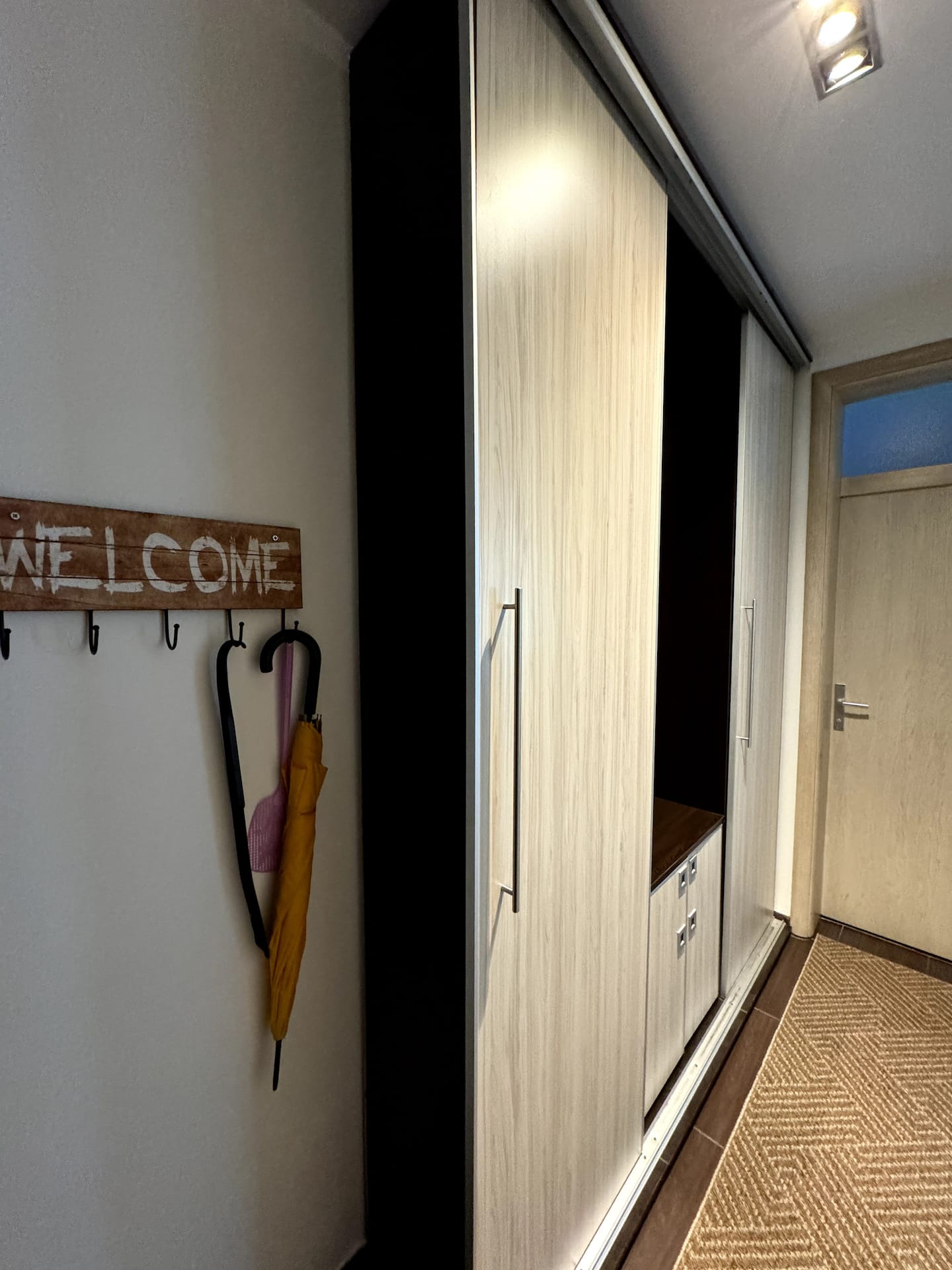 Entry hallway with wardrobe and a welcome sign