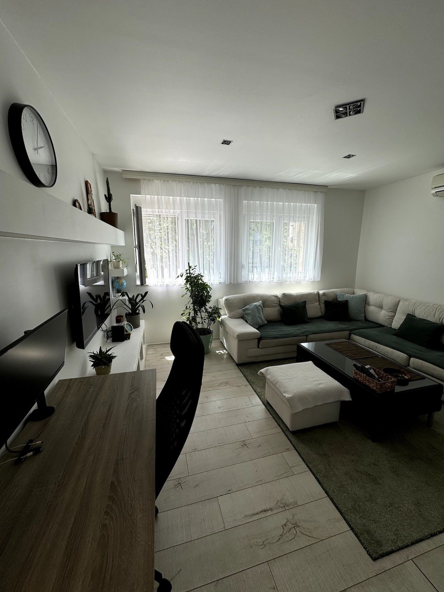 Living room from another angle showing the sofa and workspace together