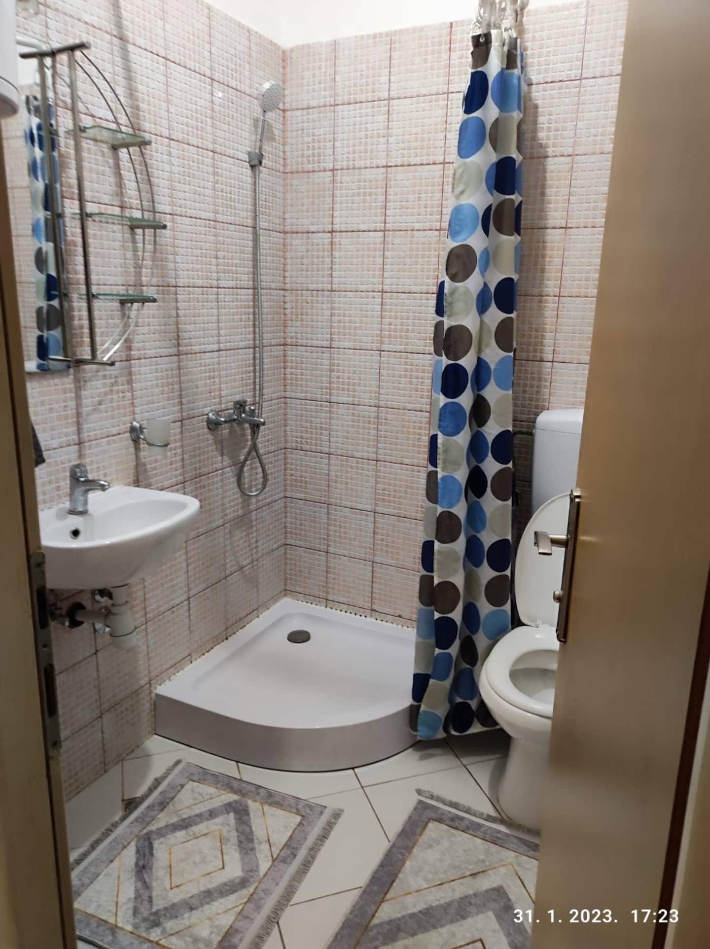 Bathroom with a corner shower, toilet and basin