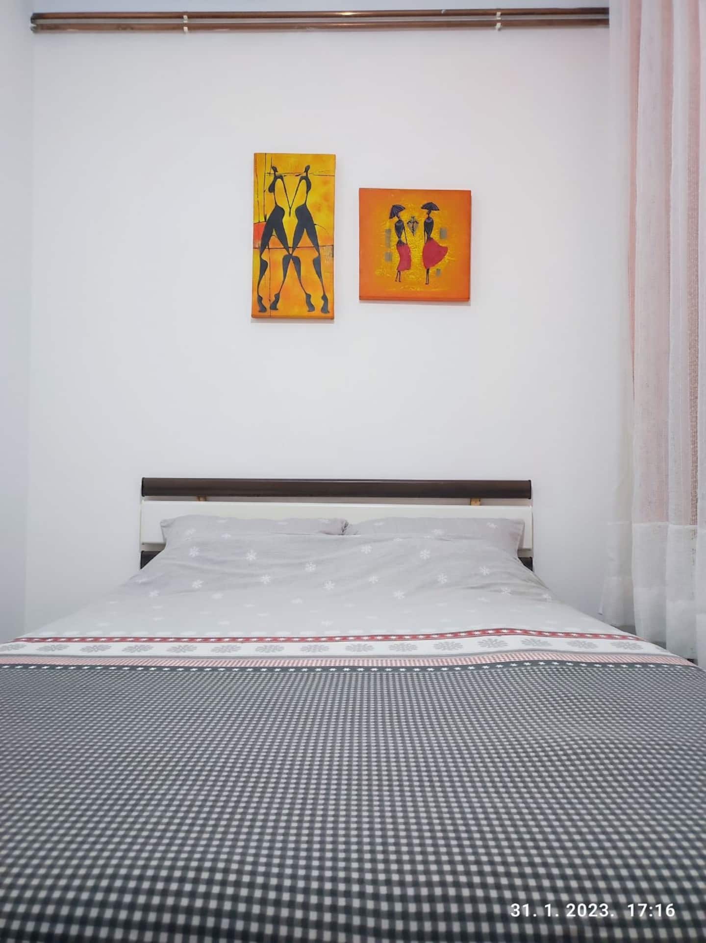 The double bed seen straight on with artwork above